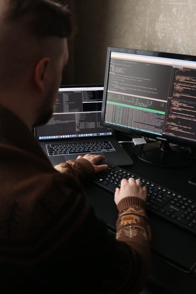 Person in Brown Long Sleeve Shirt Typing on a Keyboard